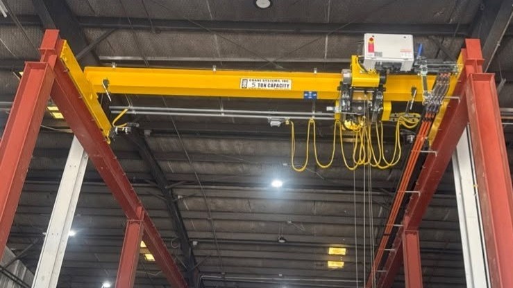 Technician installing an overhead crane in an industrial facility in North Texas